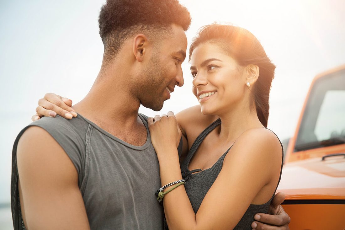 Smiling couple flirting in the sun